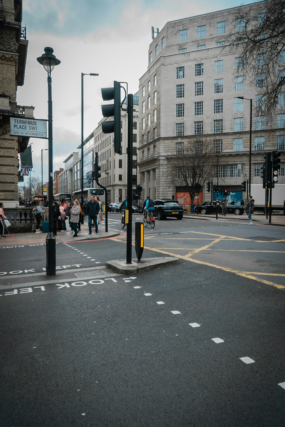 a city street filled with lots of traffic next to tall buildings