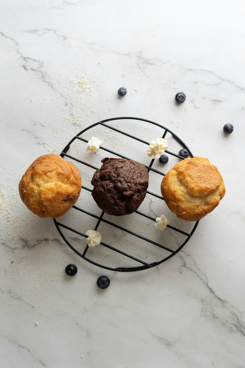 three muffins sitting on top of a wire rack