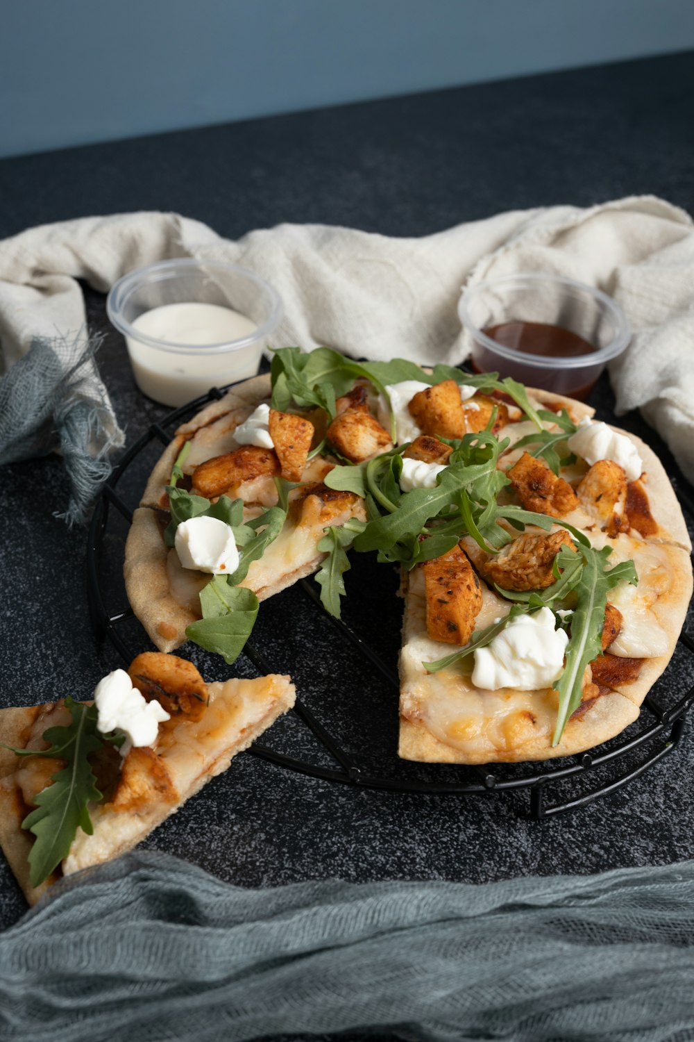 a pizza sitting on top of a black plate