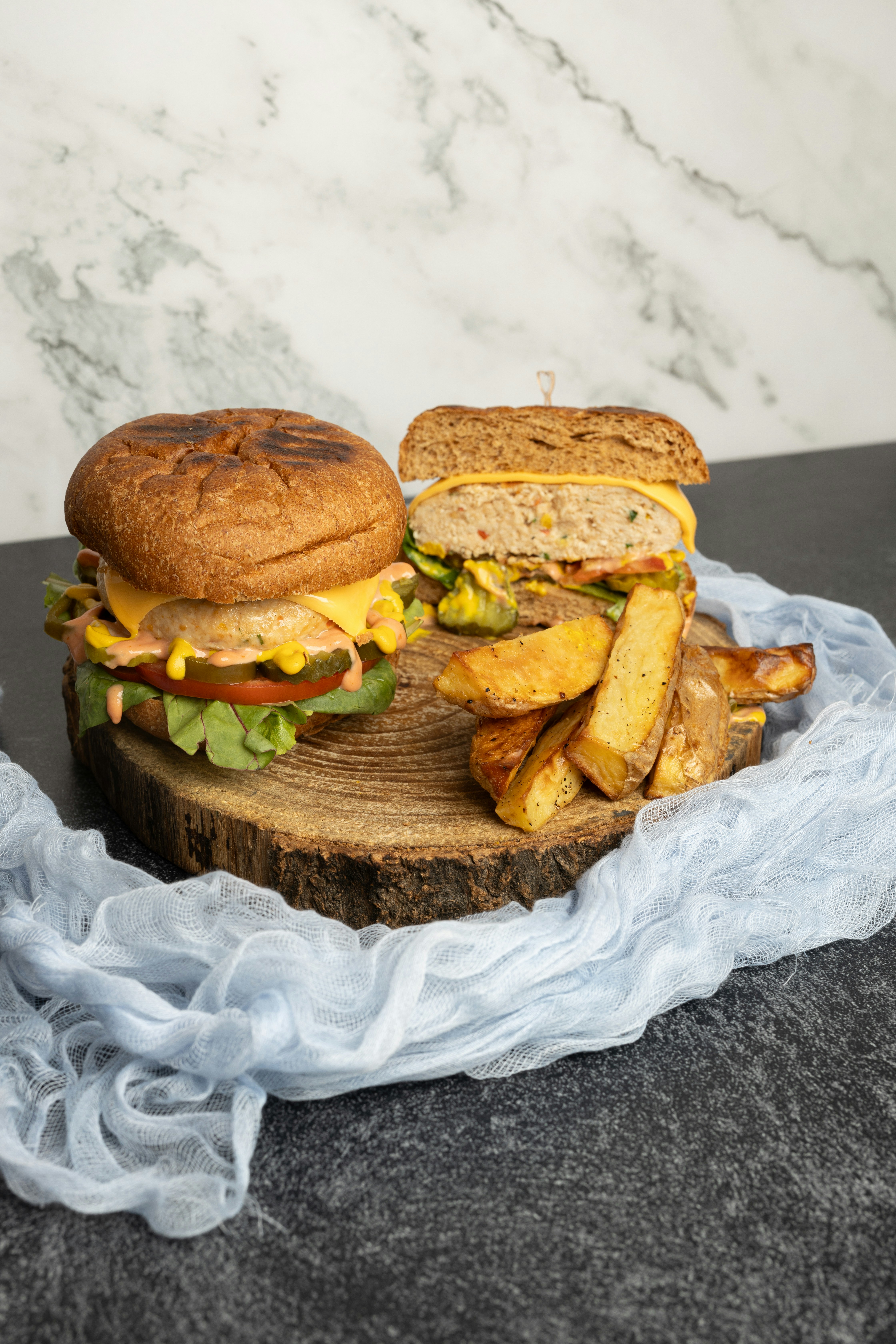 a sandwich and french fries on a wooden board