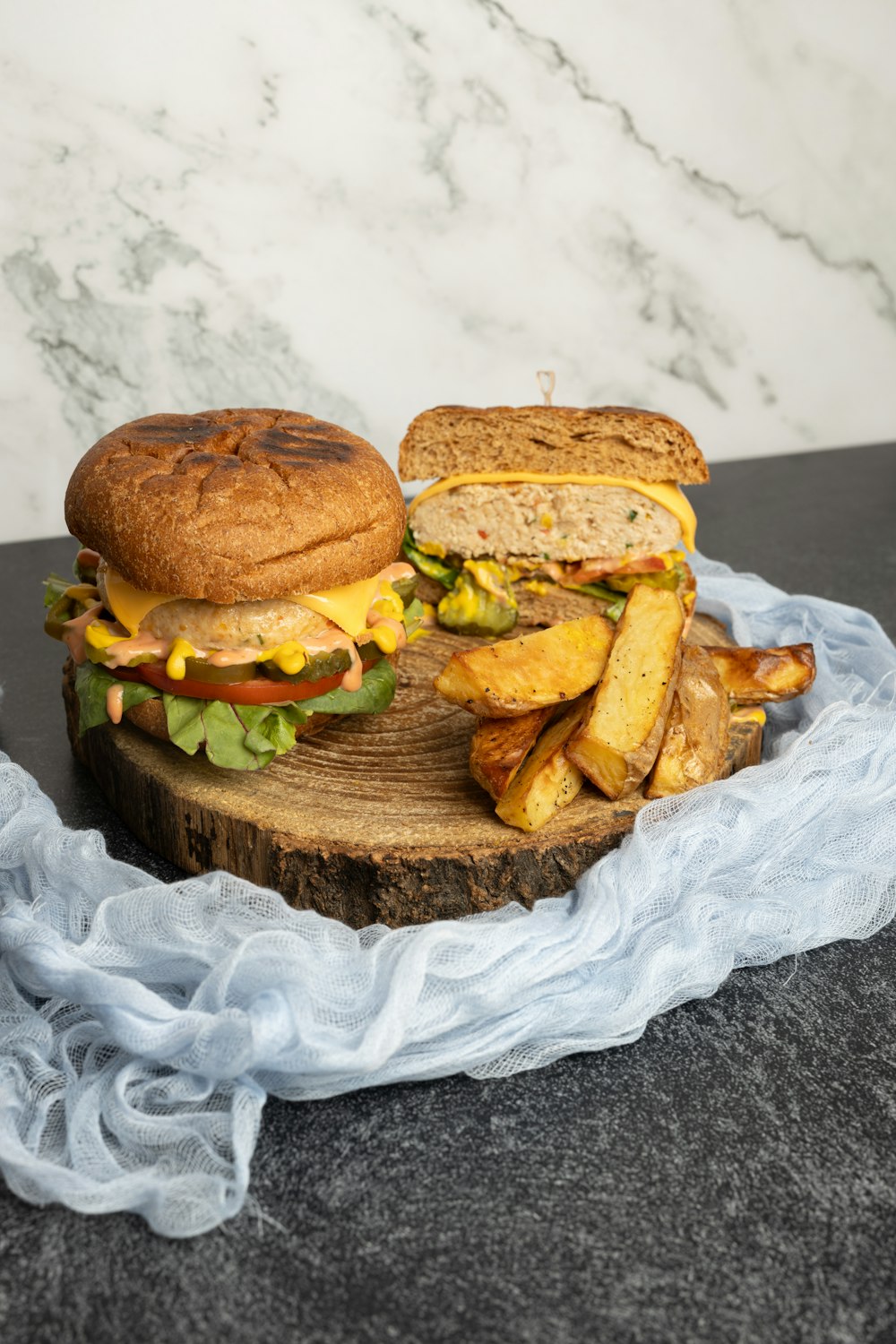 a sandwich and french fries on a wooden board