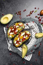 avocados and other fruits are on a towel