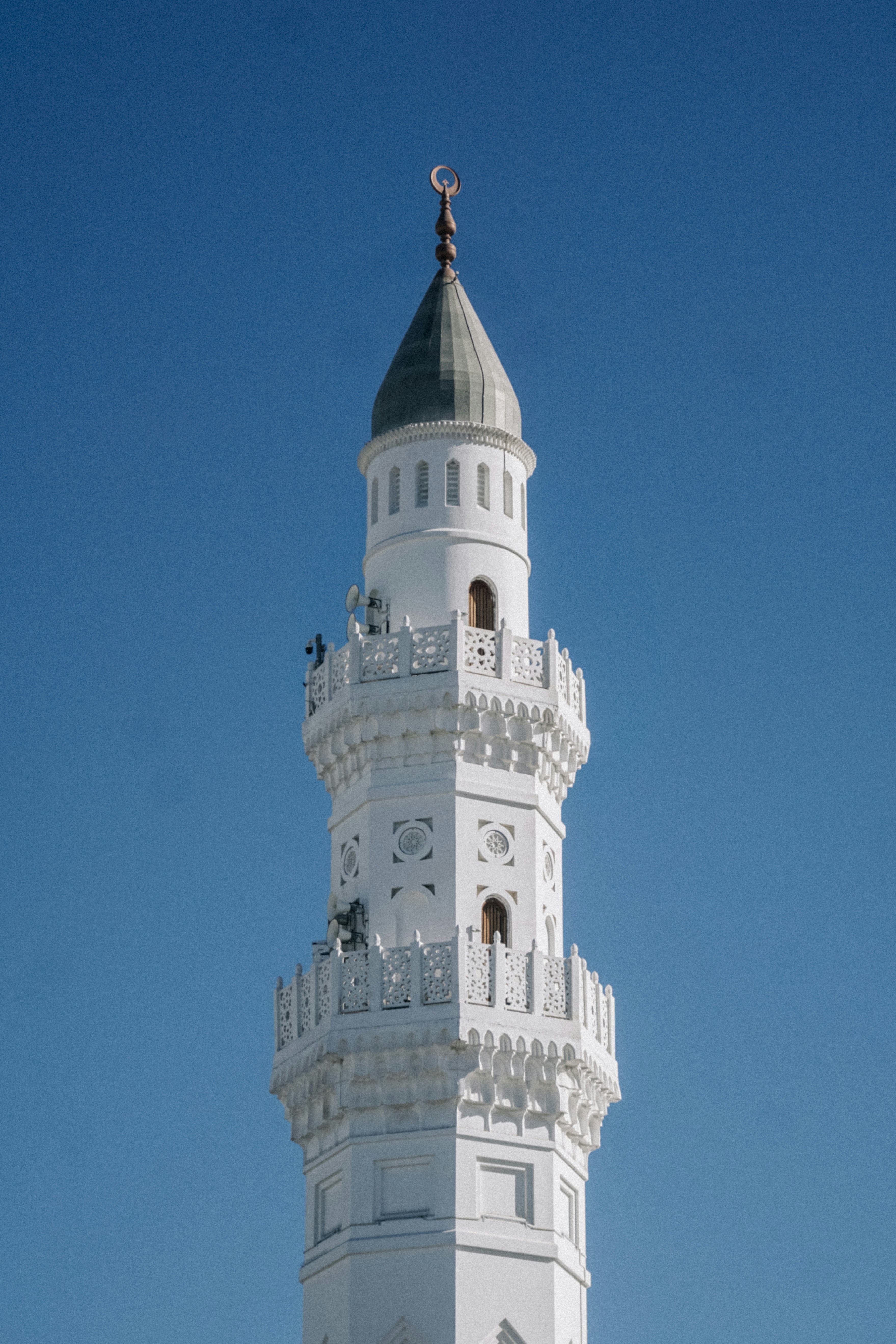 a tall white tower with a clock on the top