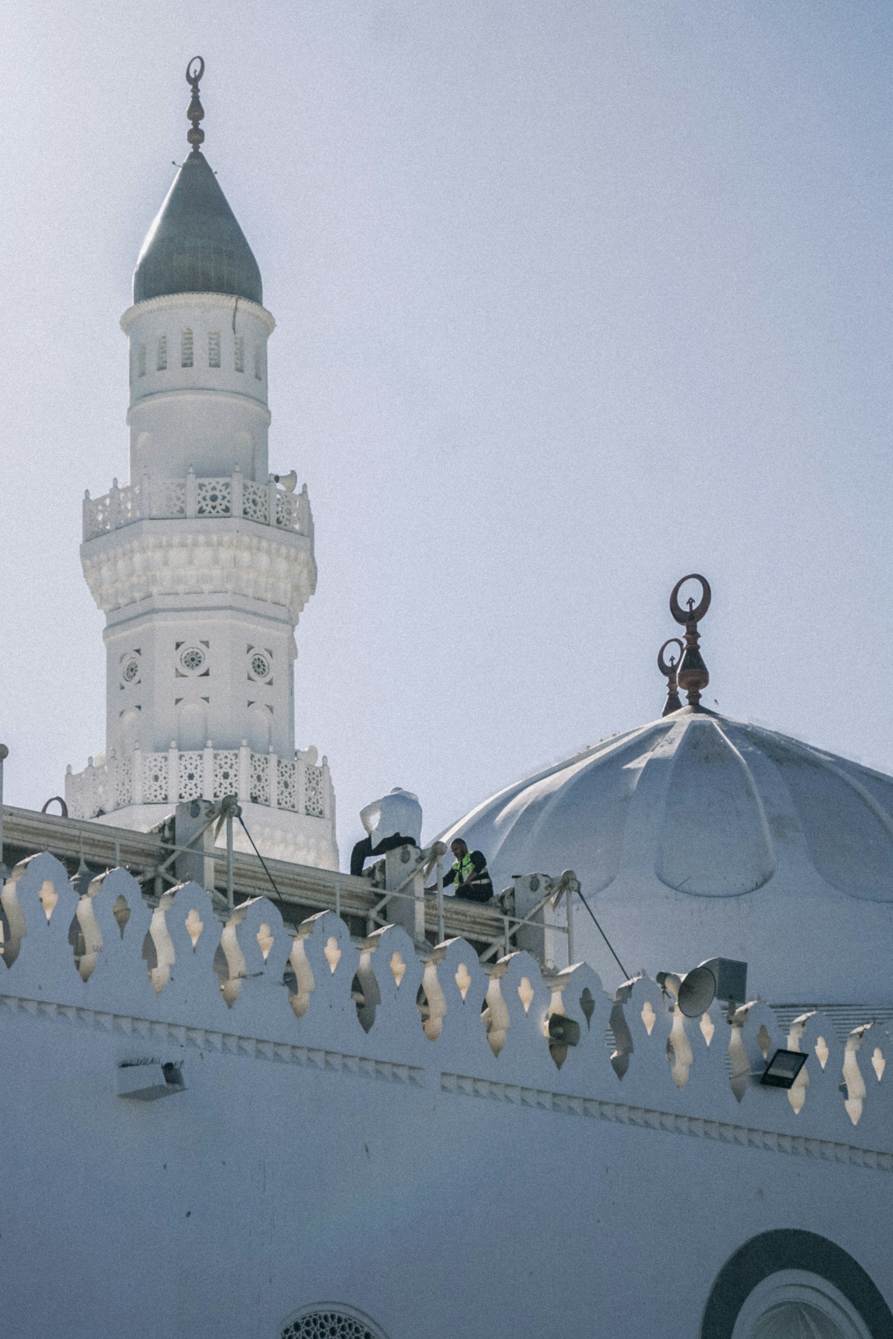 a large white building with a clock tower in the background