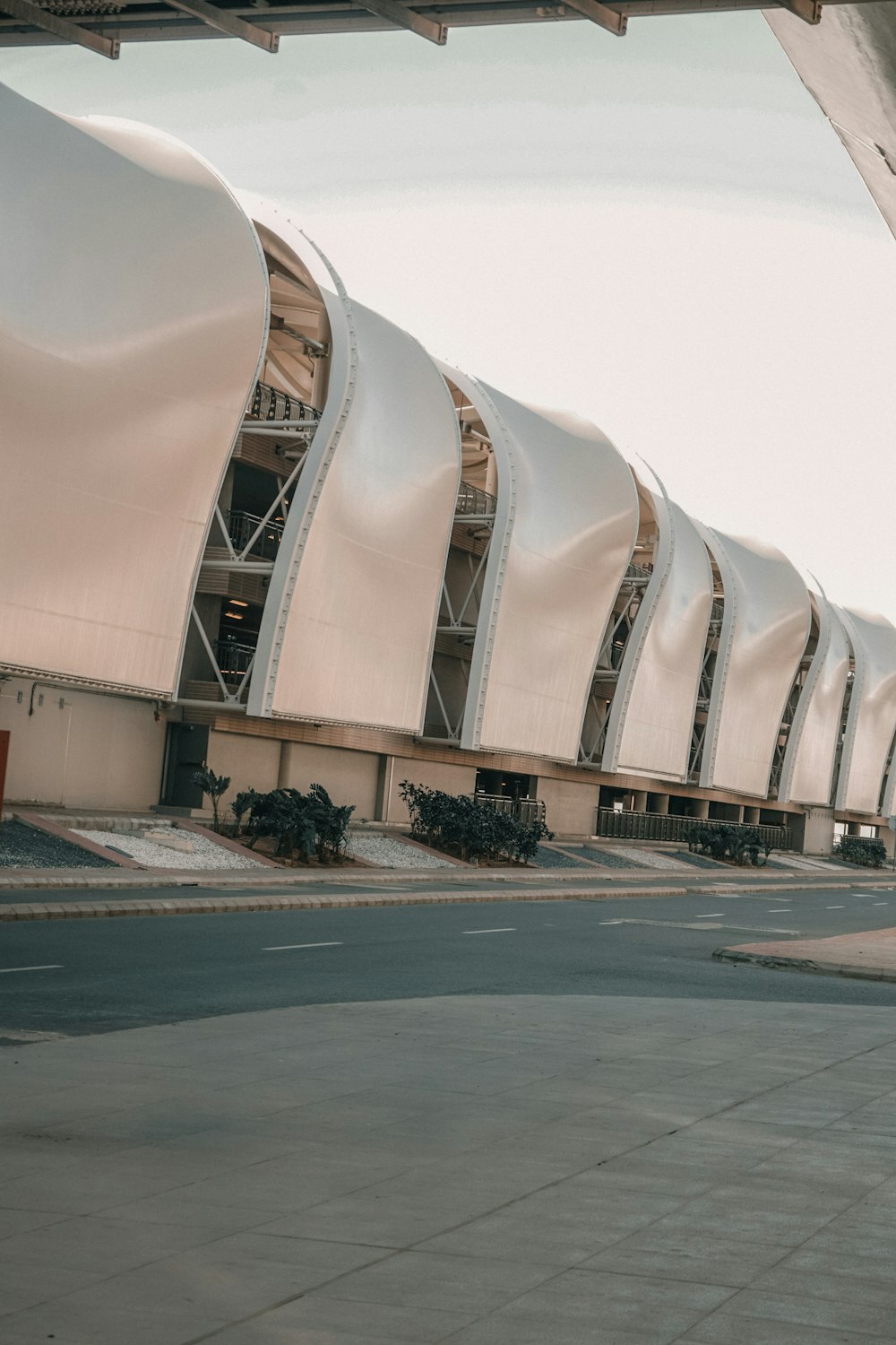 a large white building sitting on the side of a road