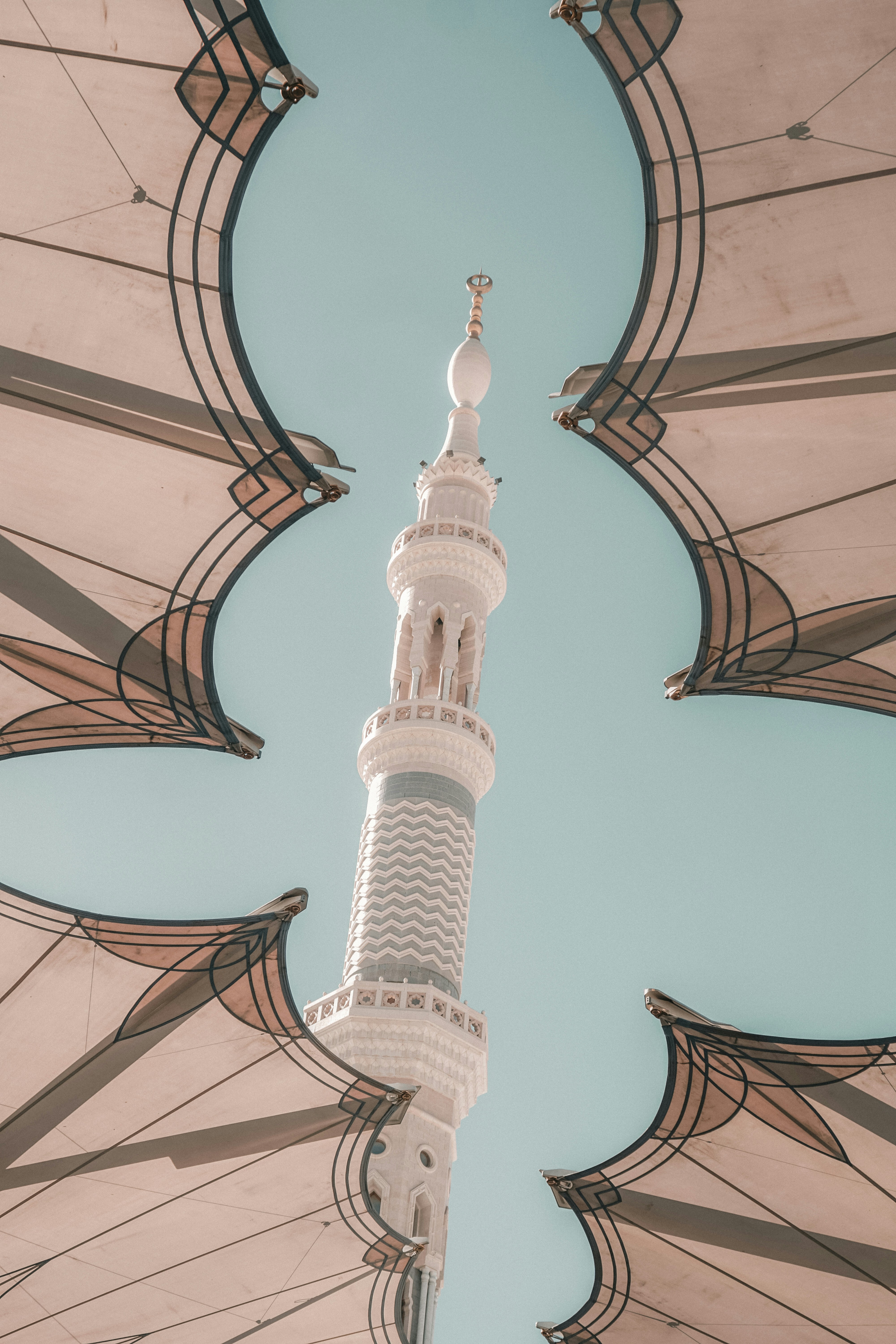 a tall white building with a clock on it's side