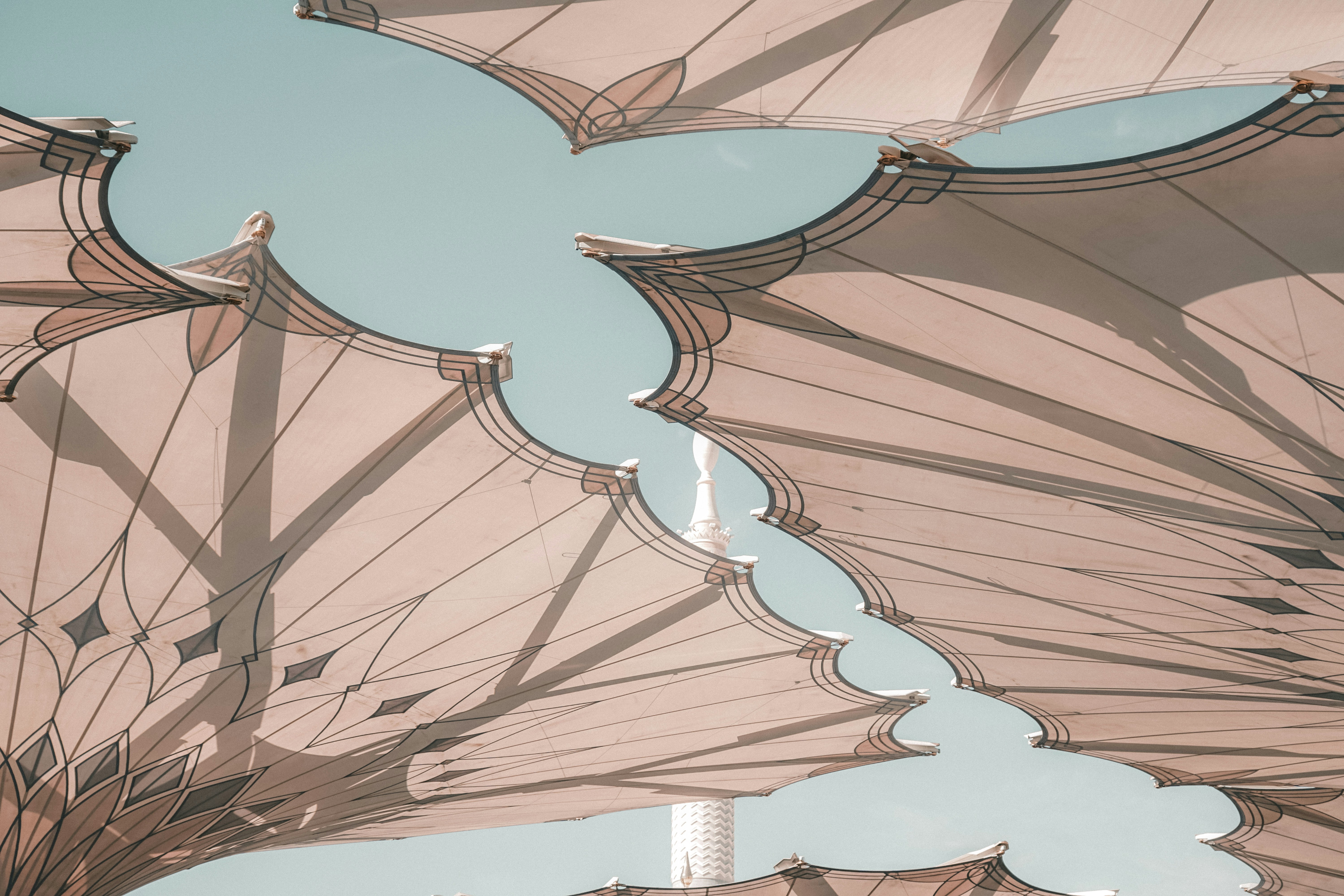 a close up of a large umbrella with a sky background