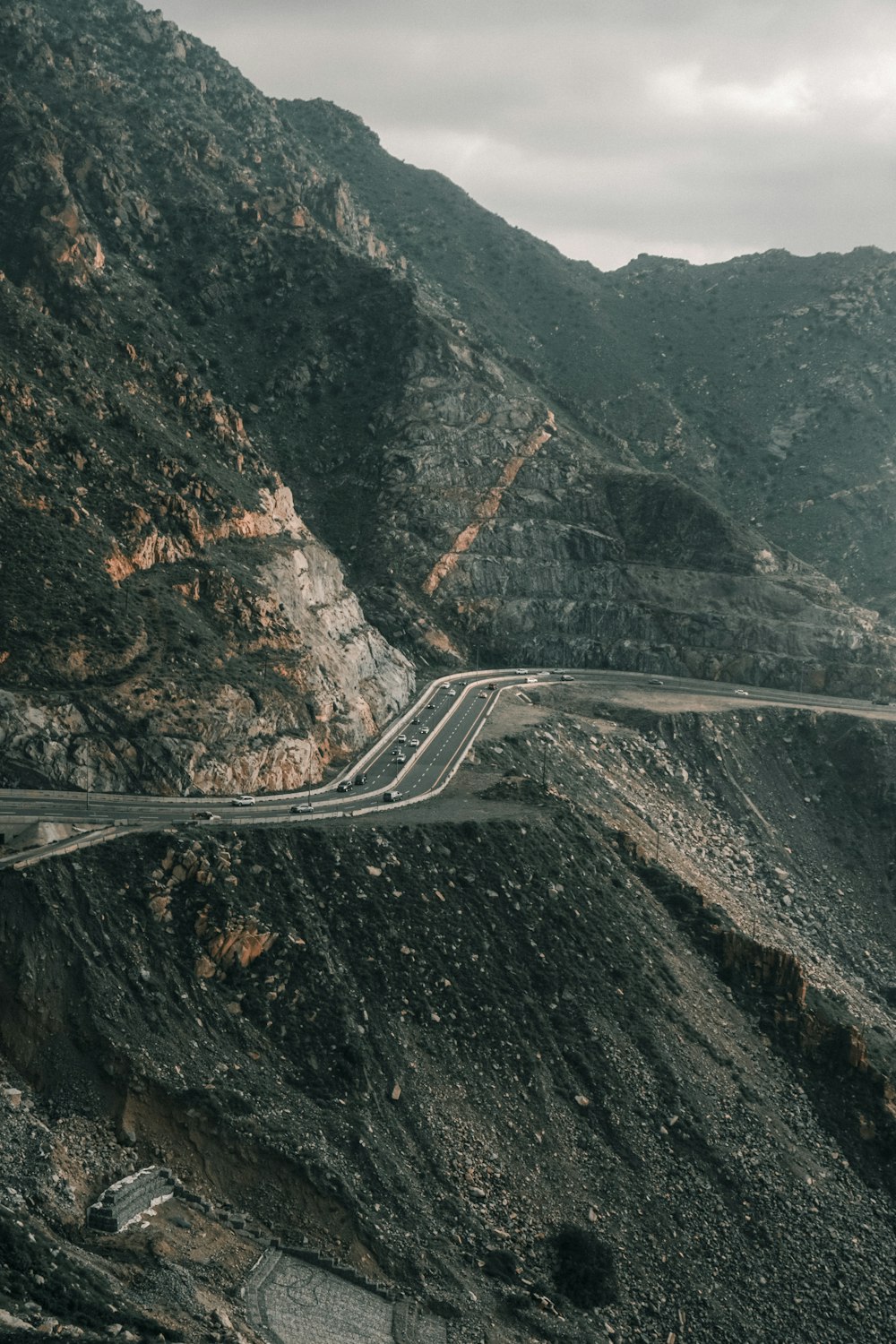 a winding mountain road in the middle of a mountainous area