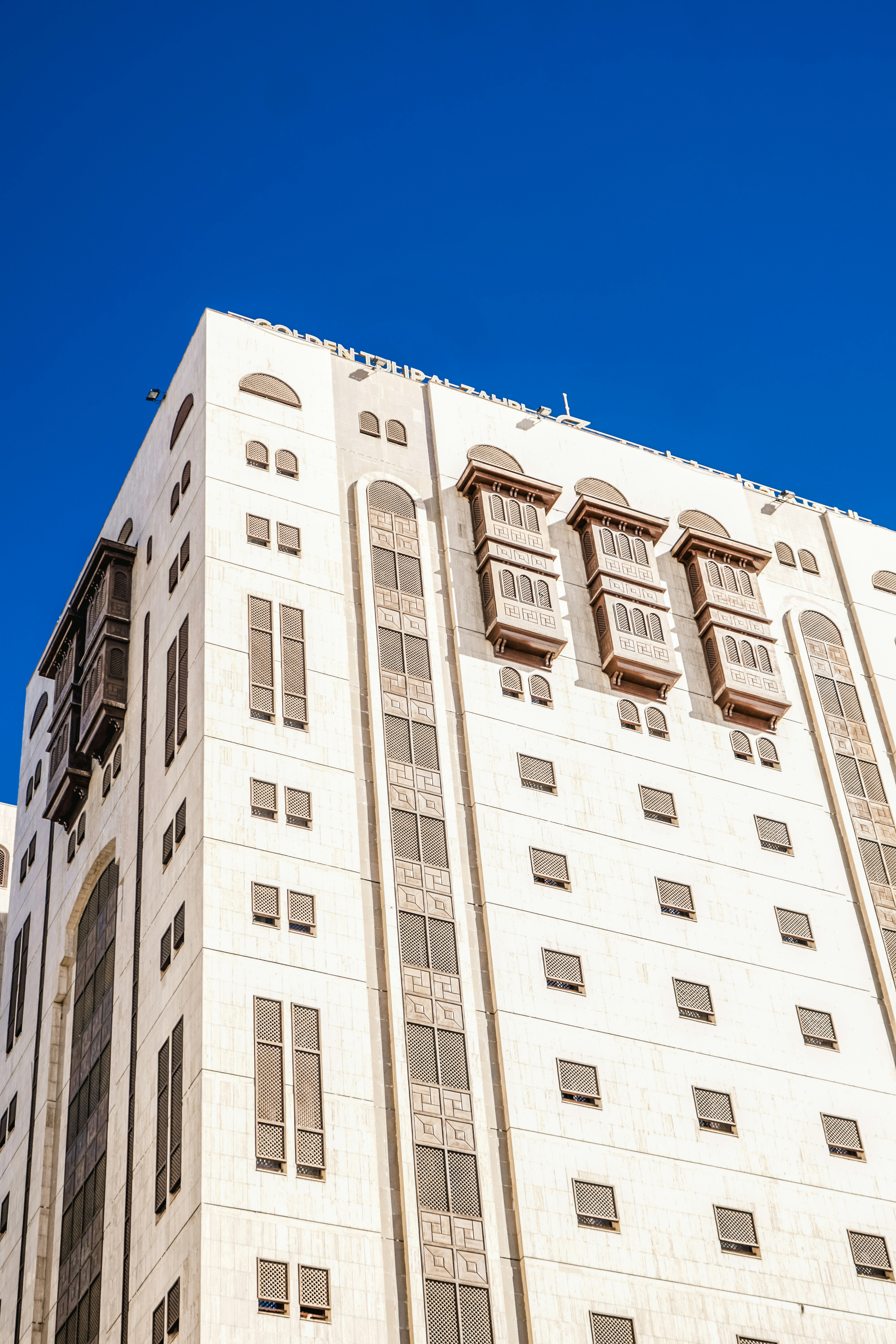a tall white building with lots of windows