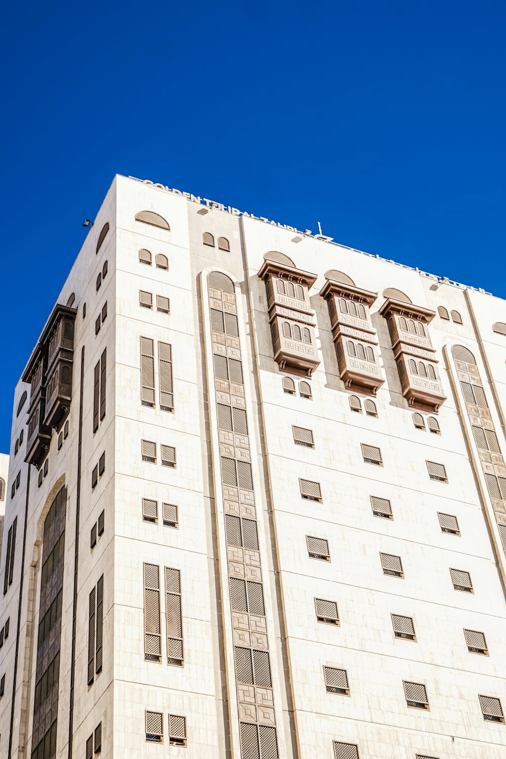 a tall white building with lots of windows