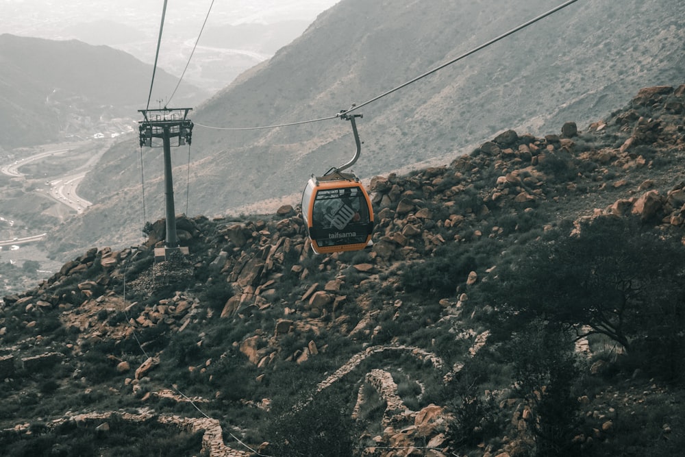 a cable car going up a mountain side