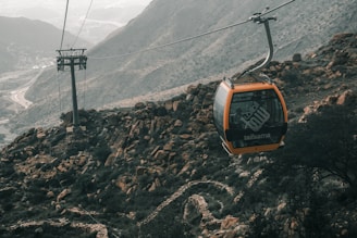 a cable car going up the side of a mountain