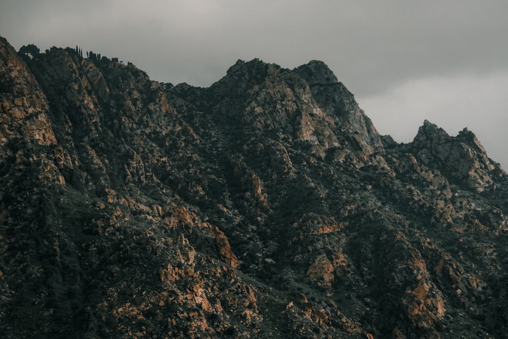 a very tall mountain with a cloudy sky in the background