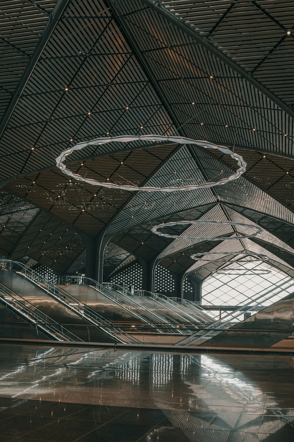 a large open space with a circular metal object hanging from the ceiling