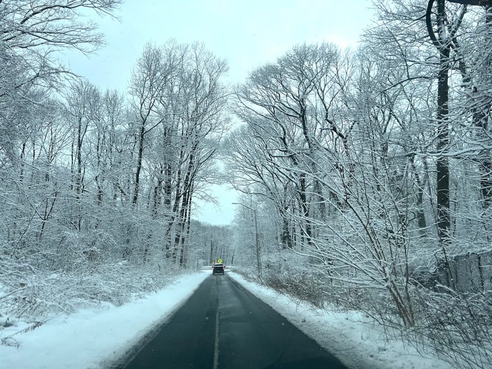 a car driving down a snow covered road