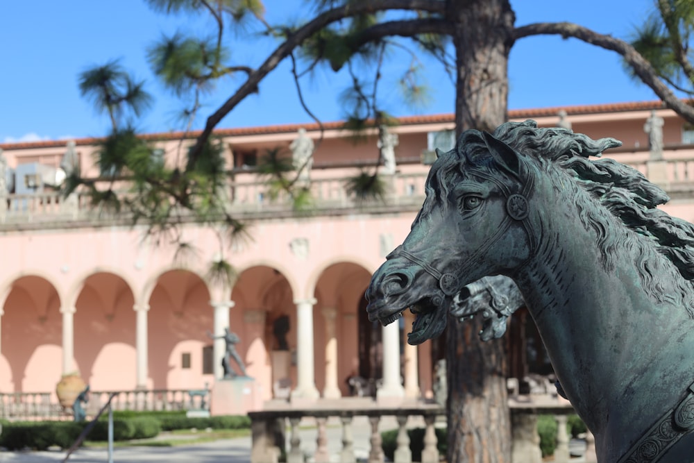 a statue of a horse in front of a building