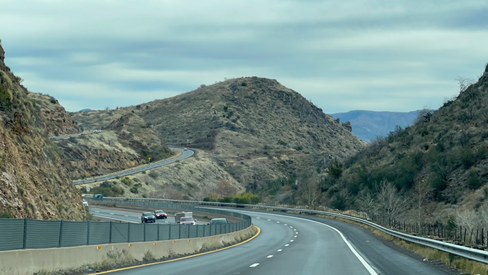 a view of a highway with mountains in the background