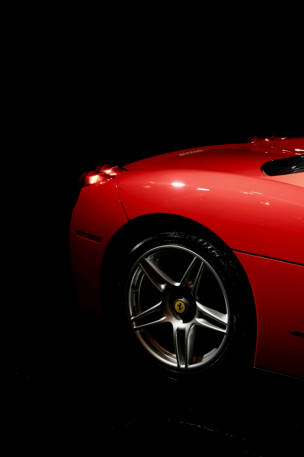 a red sports car parked in the dark