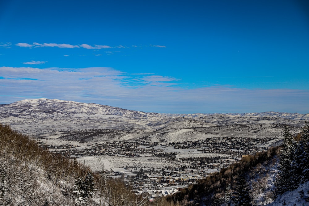 a view of a snowy mountain range with a blue sky in the background