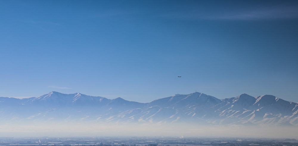 a plane flying over a large mountain range