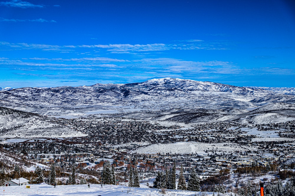 a view of a snowy mountain range with a ski lift in the foreground