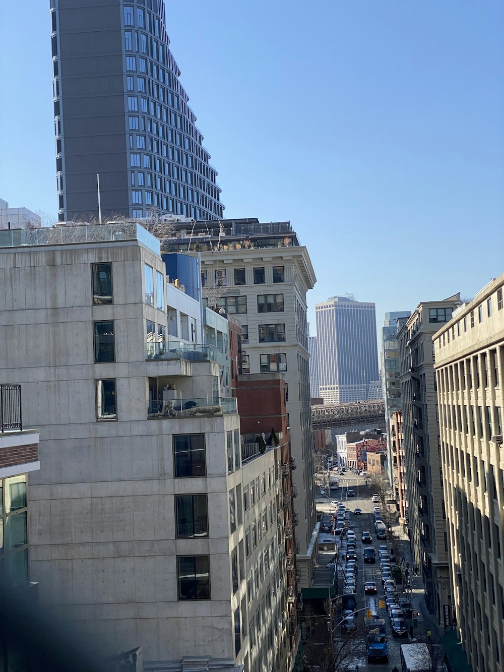 a city street filled with lots of traffic next to tall buildings