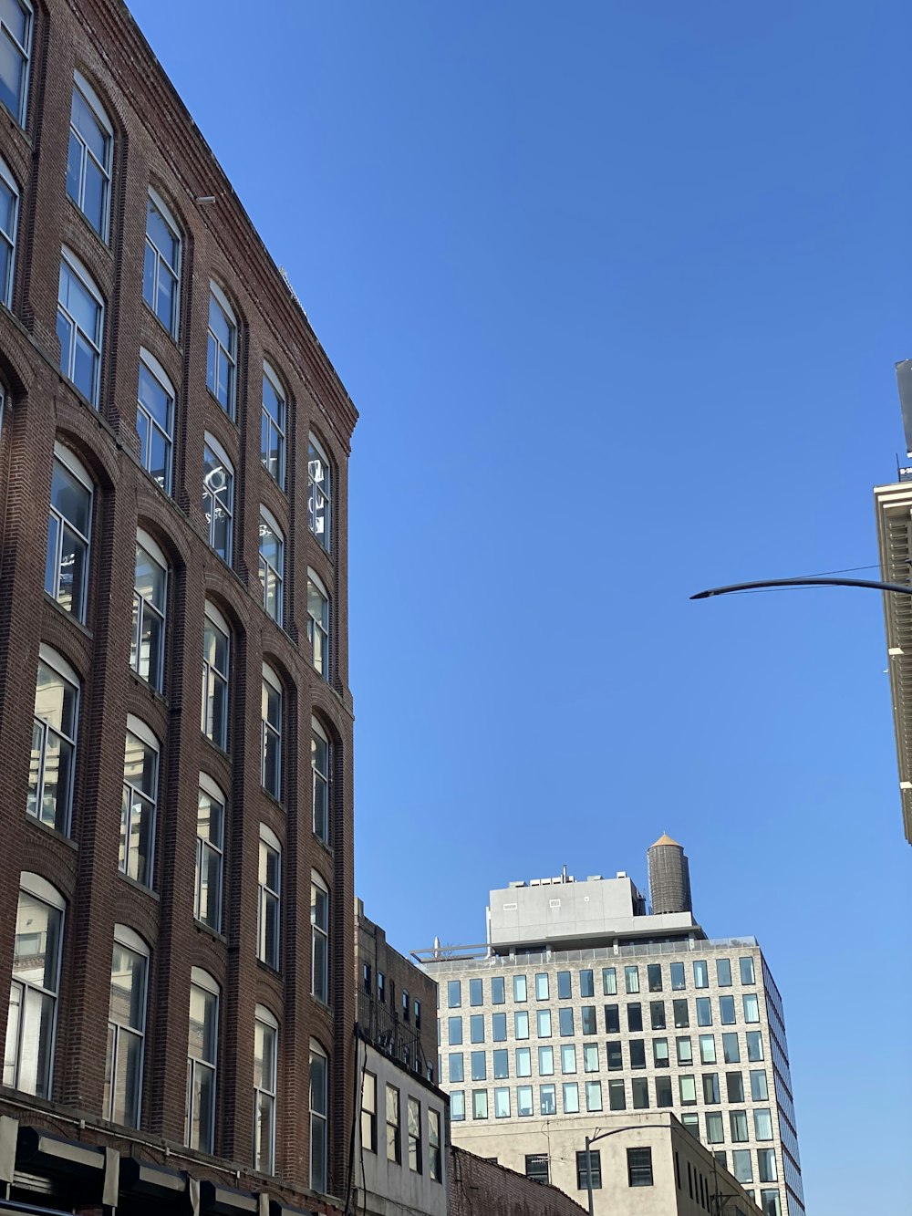 a tall brick building sitting next to a traffic light