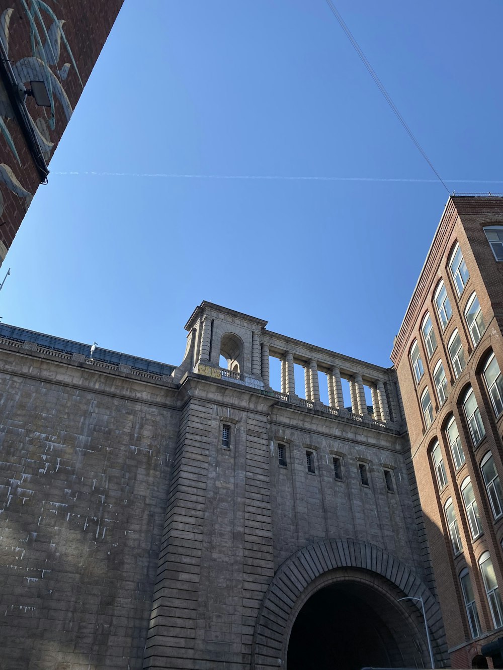 a tall brick building with a clock on it's side