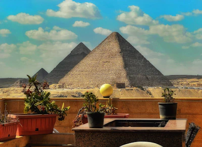 a view of the pyramids of giza from a balcony