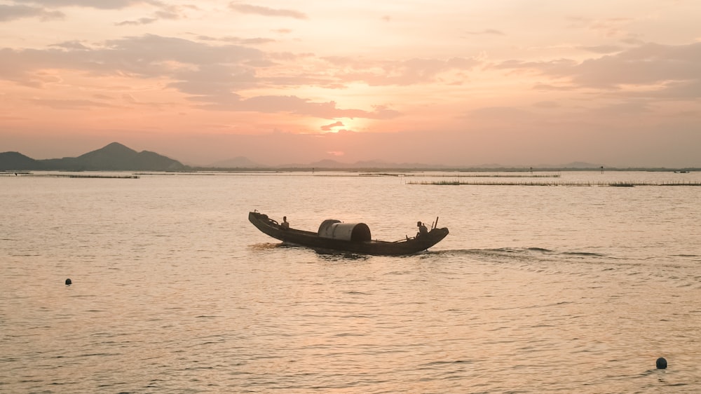 a small boat floating on top of a large body of water