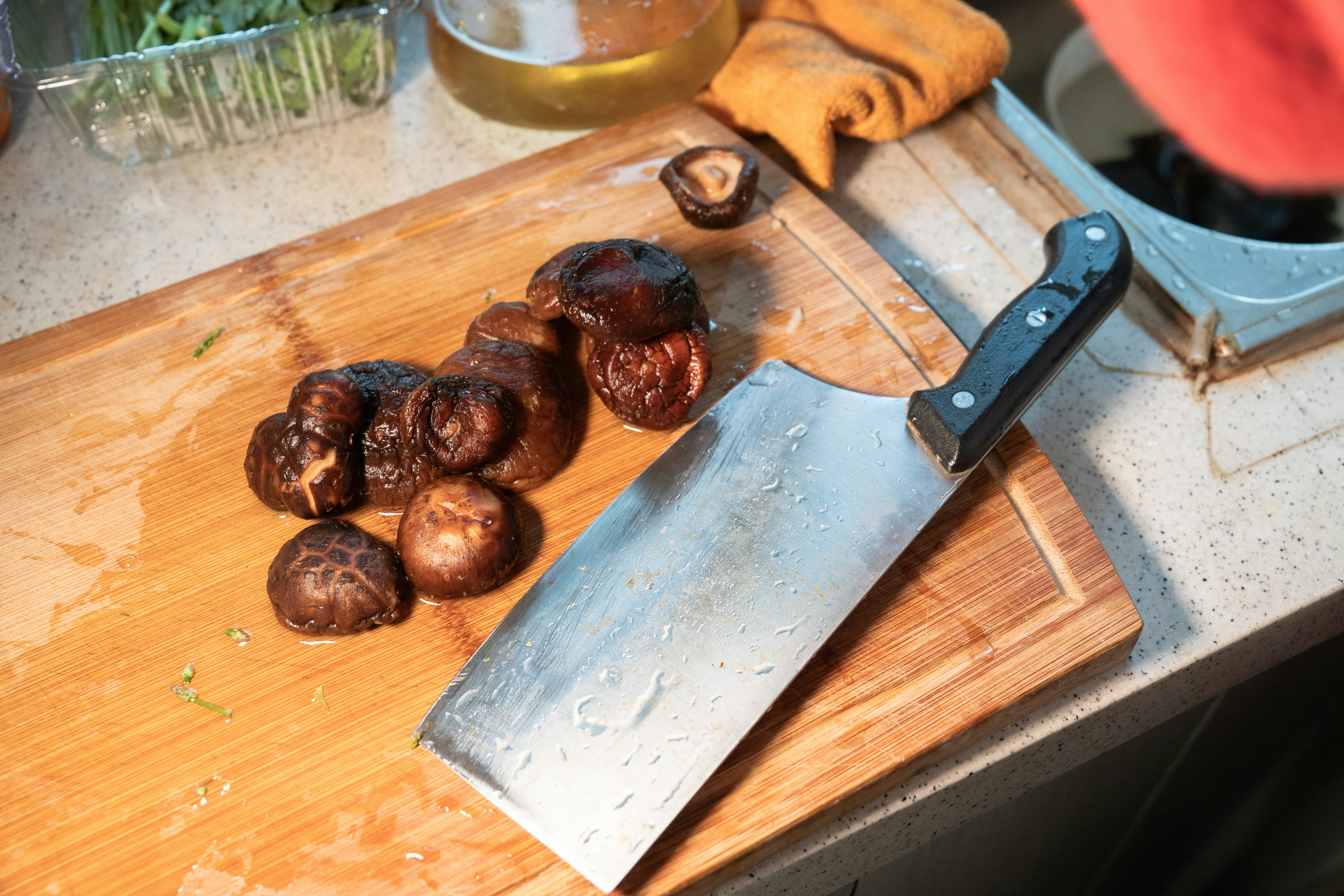 Premium shiitake mushrooms on dark wooden board, moody dramatic lighting, rich brown tones