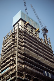 a tall building with a crane on top of it