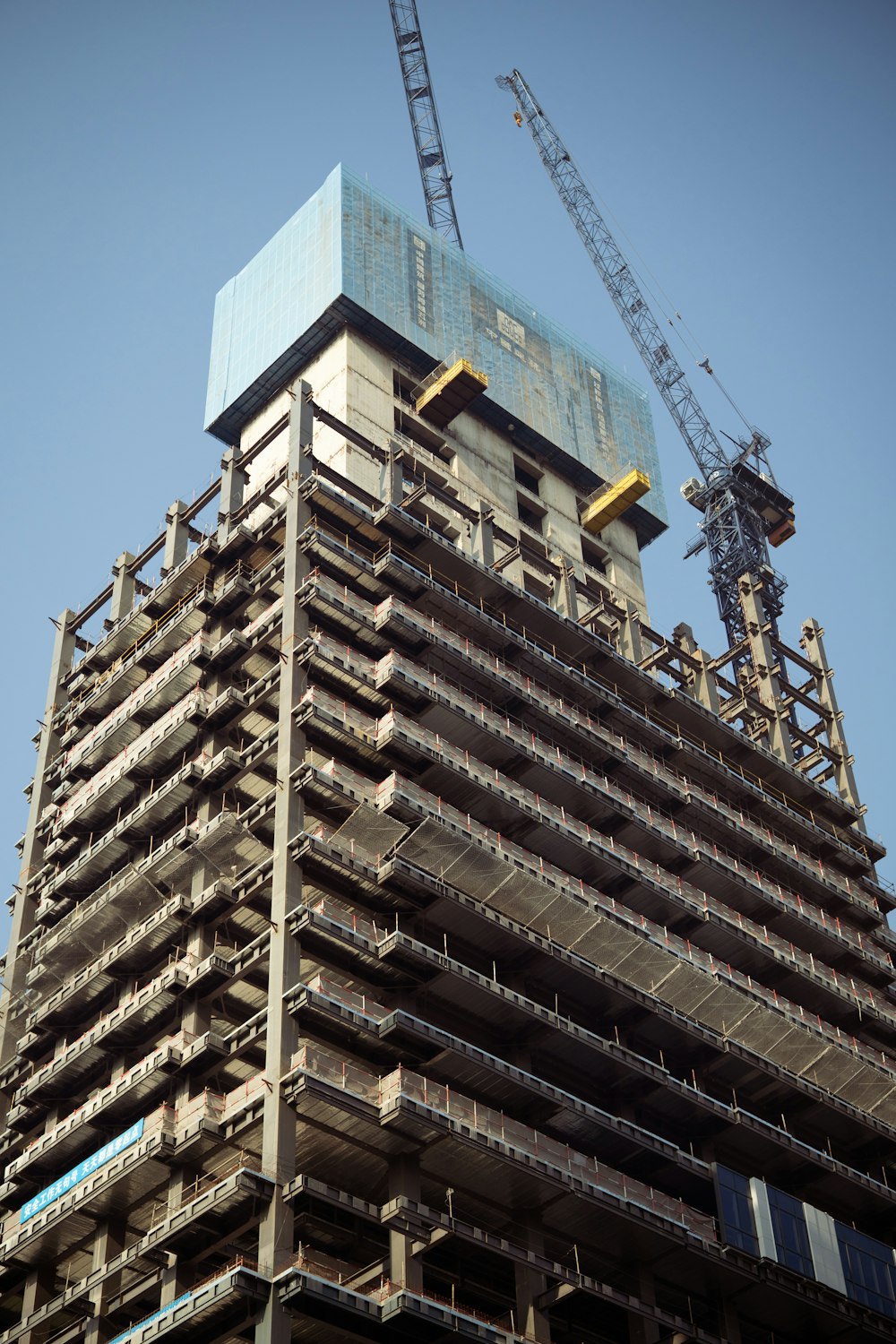 a tall building with a crane on top of it