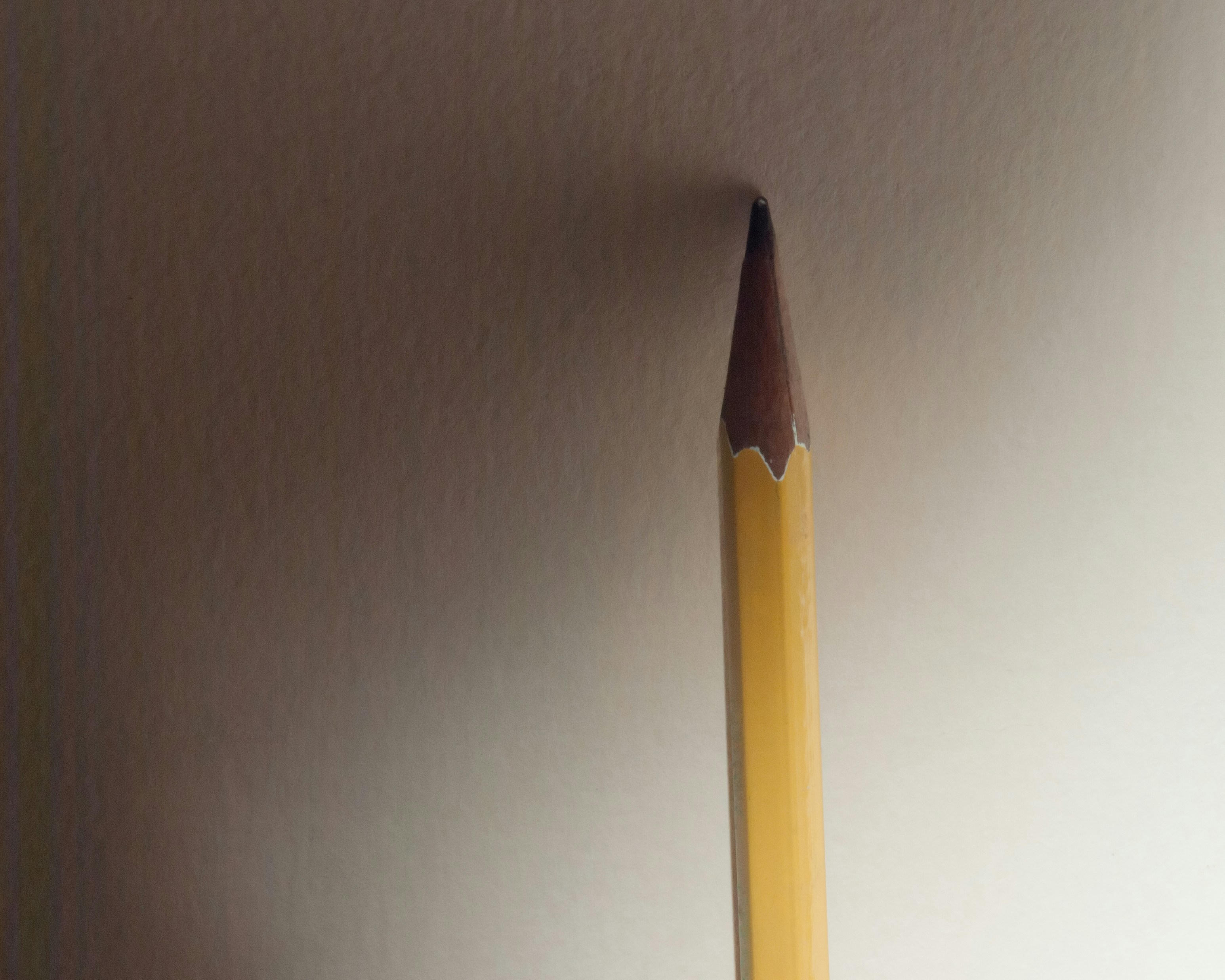 a pencil sticking out of the side of a wall