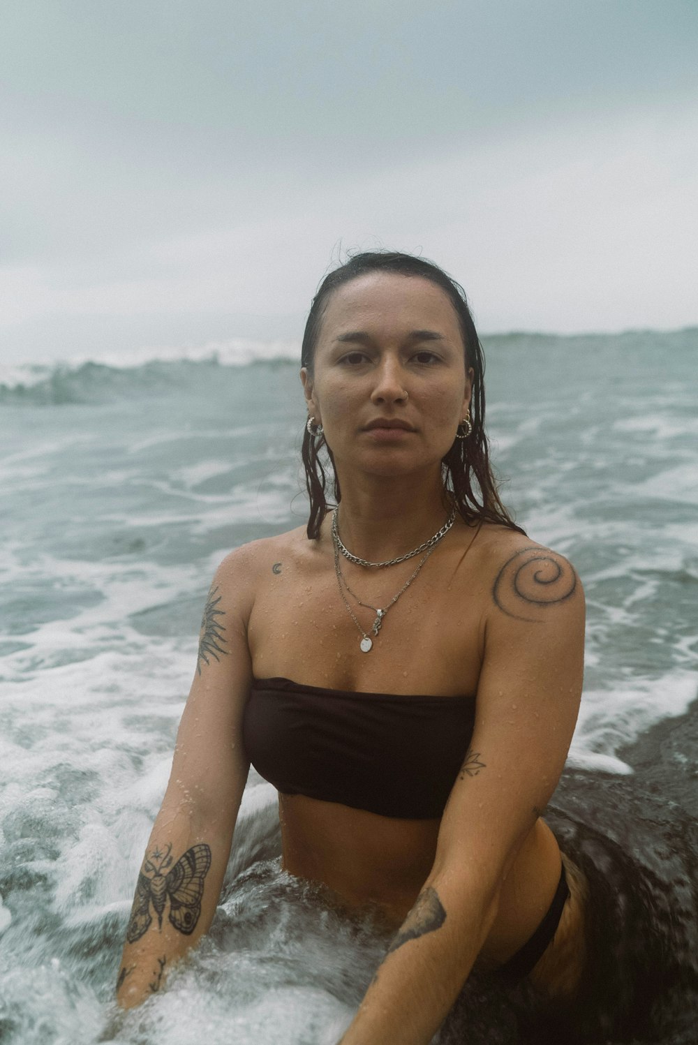 a woman in a bikini sitting in the water