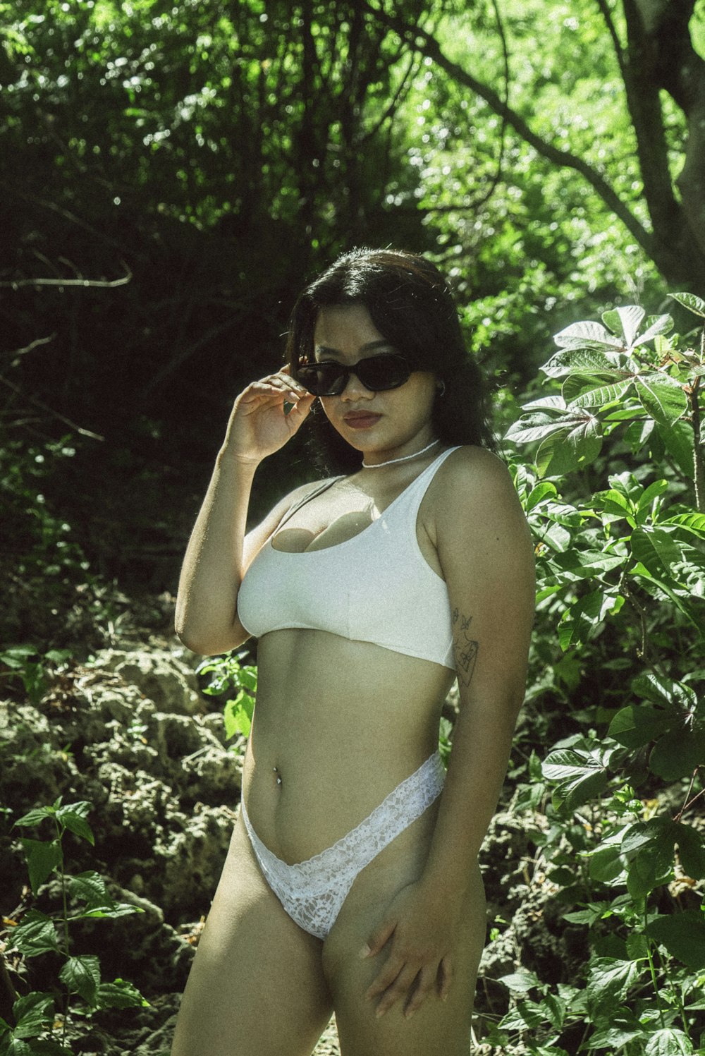 a woman in a white bikini posing for a picture