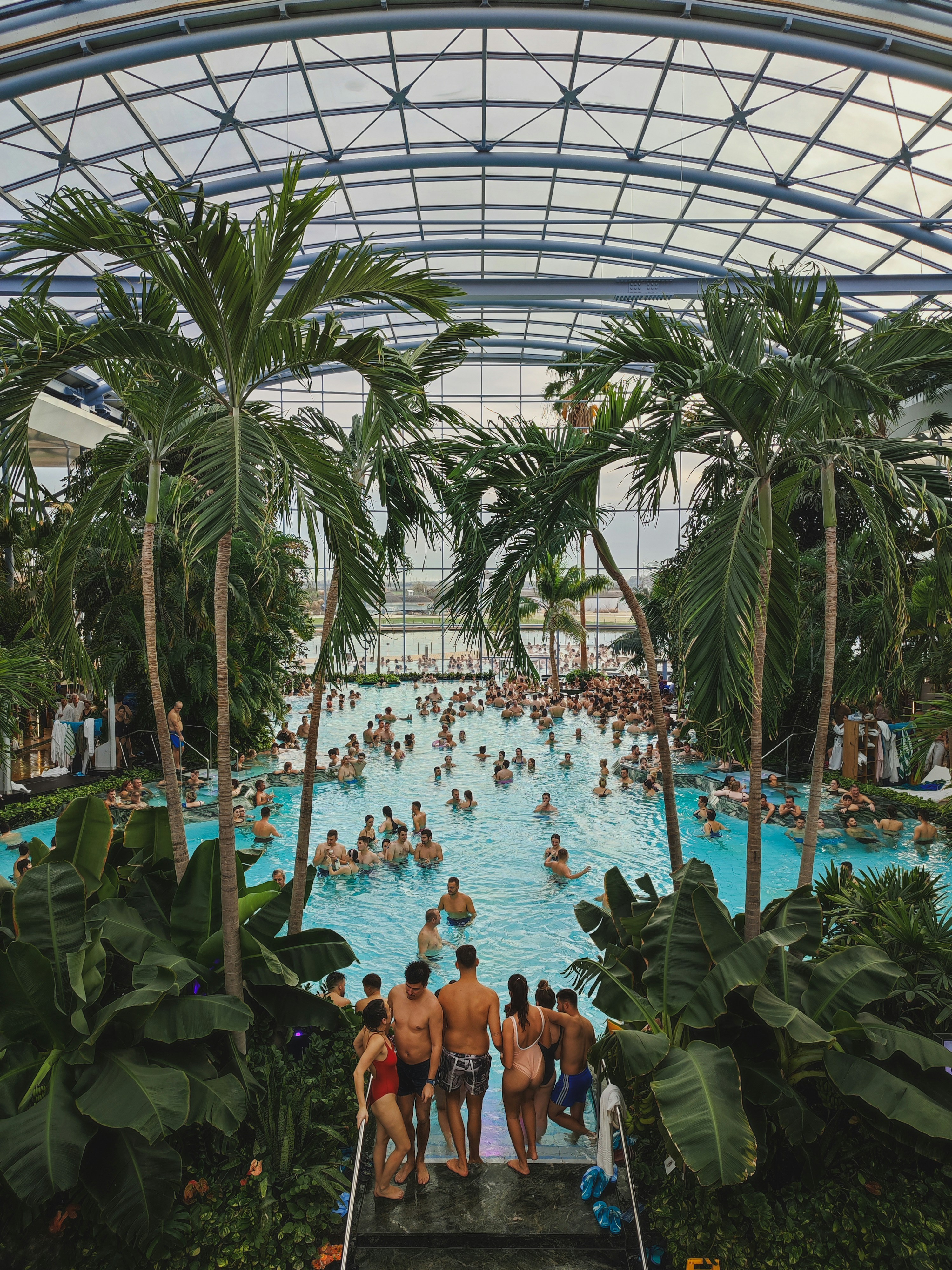 a group of people sitting around a swimming pool