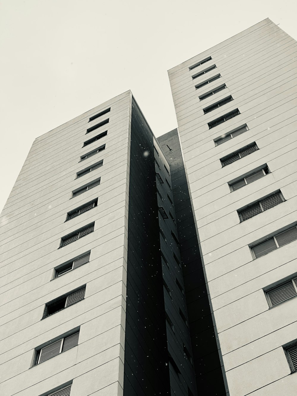 a black and white photo of two tall buildings