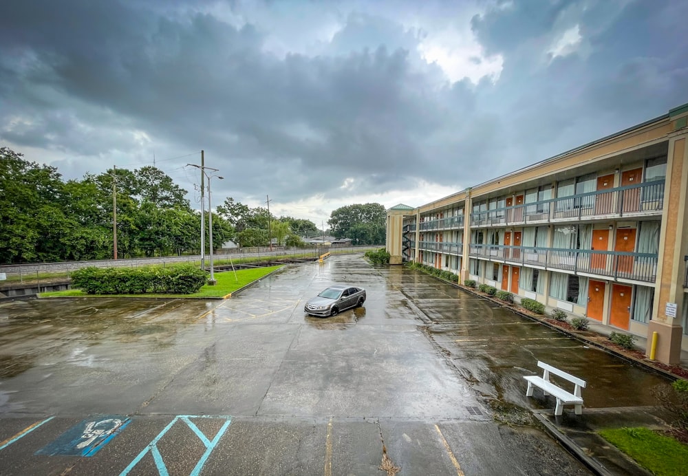 a car parked in a parking lot next to a building