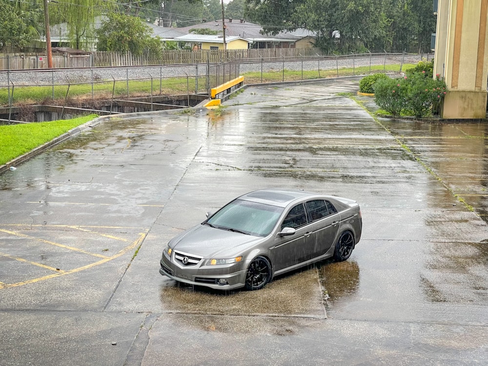 a car parked in a parking lot in the rain