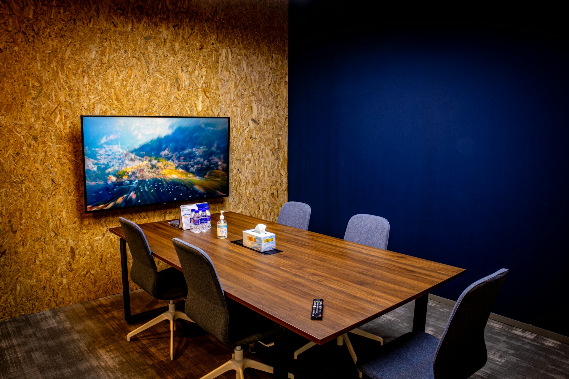 a large wooden table sitting in front of a flat screen tv