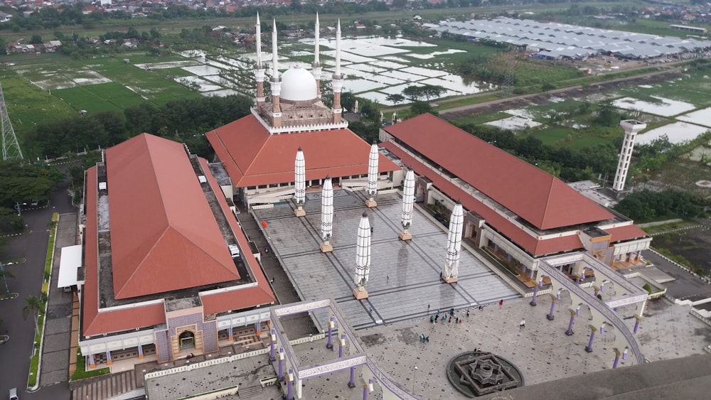 an aerial view of a building with a red roof