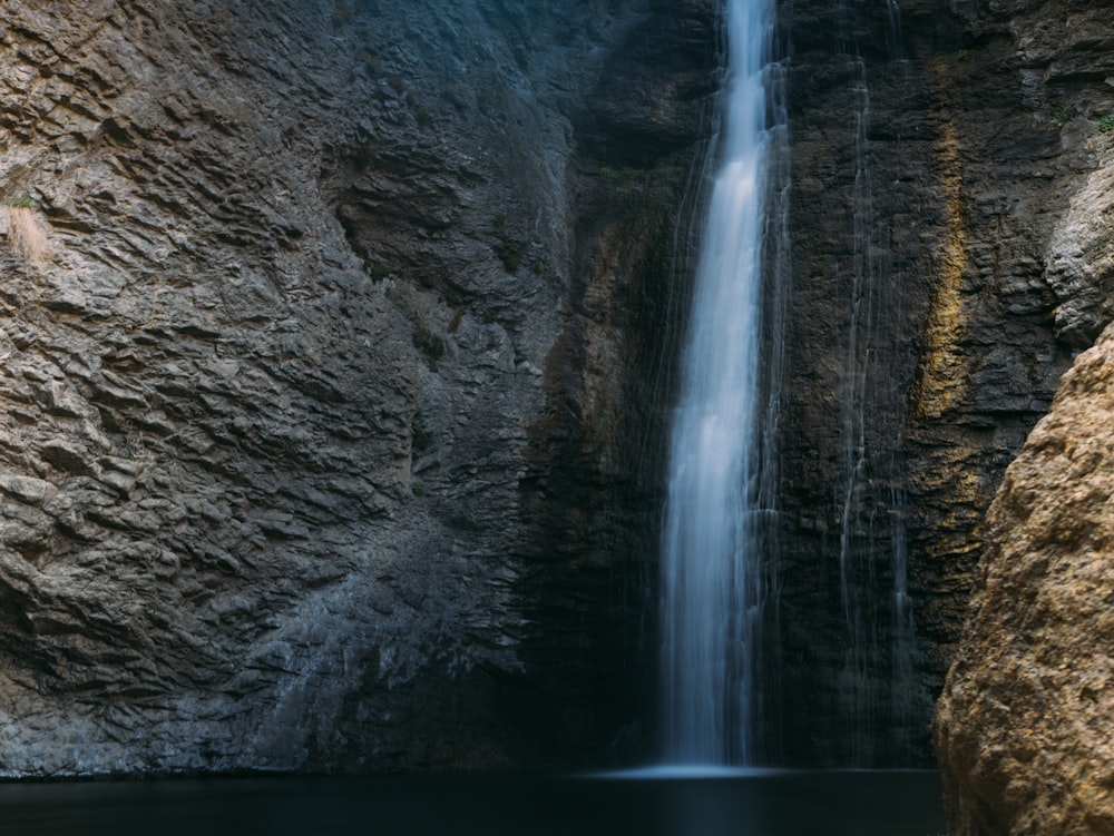 a large waterfall in the middle of a large body of water