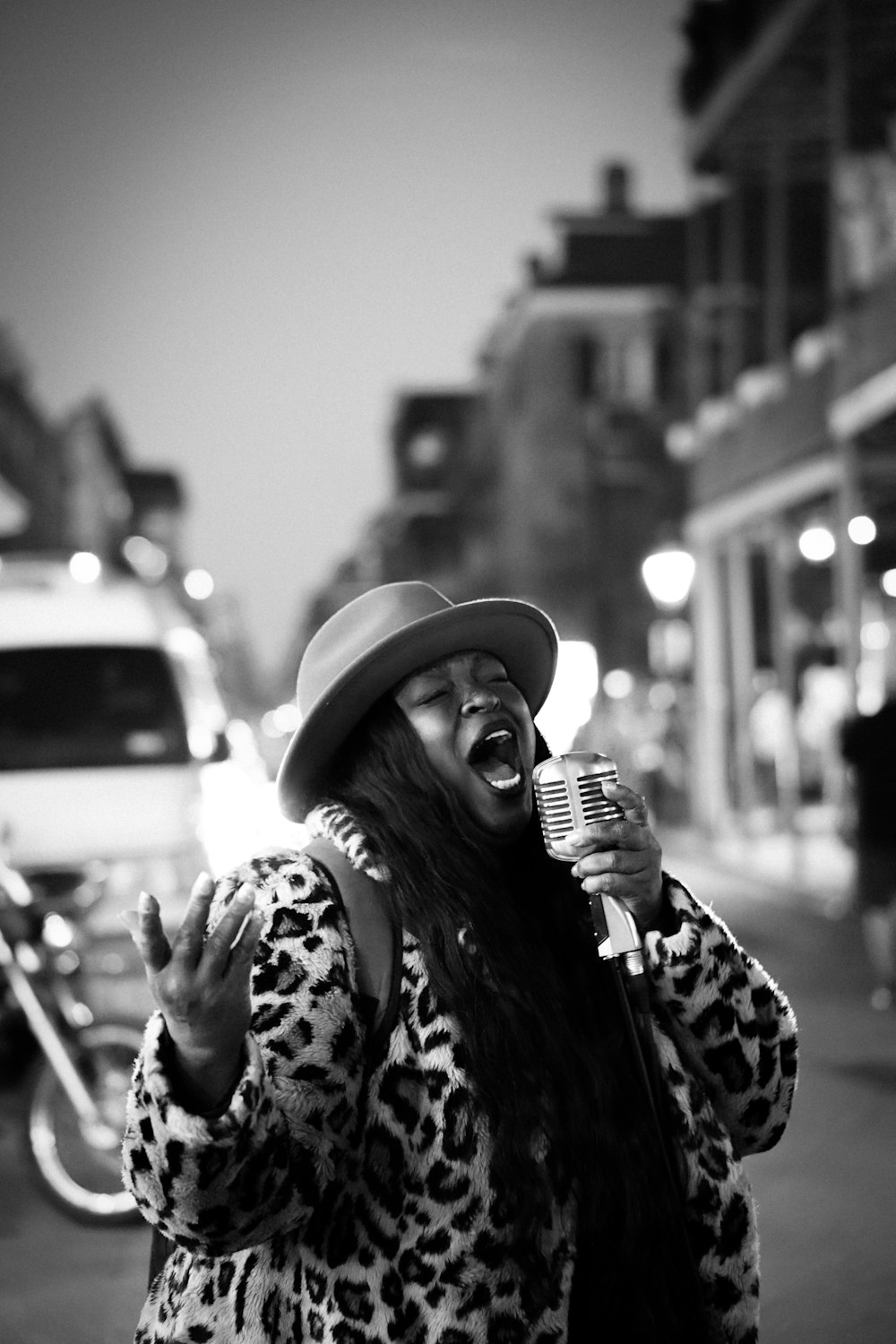 a woman with a hat and a microphone