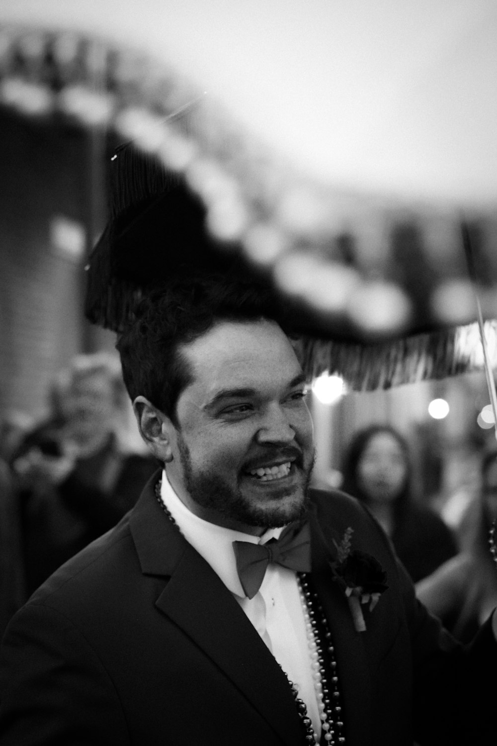 a black and white photo of a man in a tuxedo