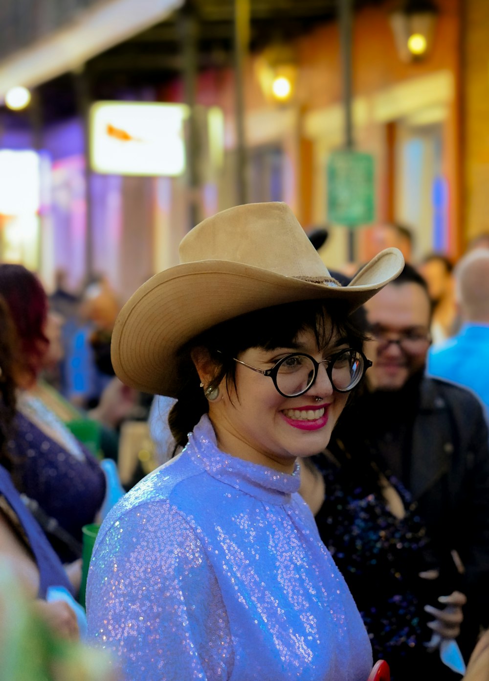 a woman wearing a cowboy hat and glasses