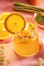 a pitcher of lemonade sitting on top of a table