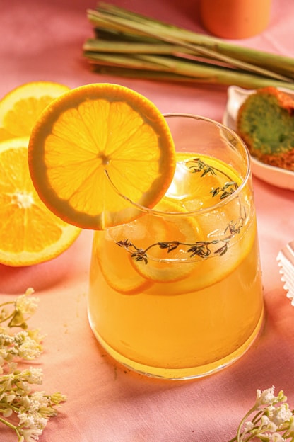 a pitcher of lemonade sitting on top of a table