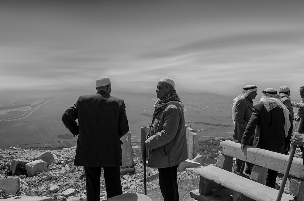 a group of people standing on top of a mountain