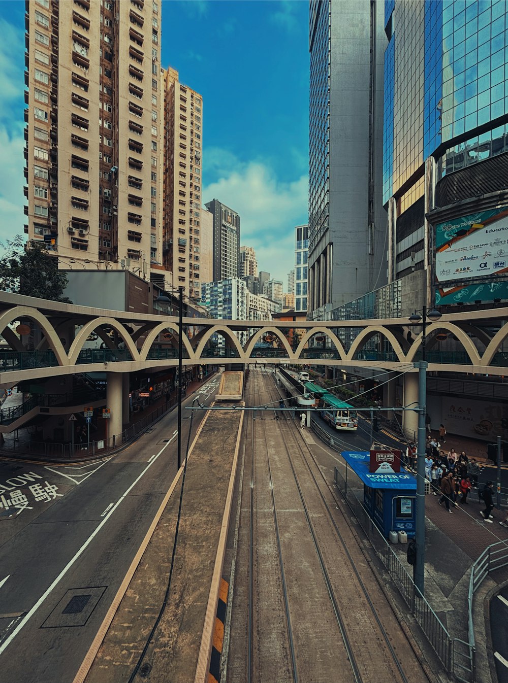 a train traveling down train tracks next to tall buildings